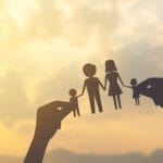 silhouette hand holding paper of family